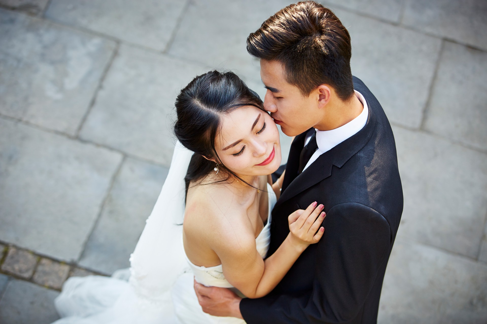 young asian wedding couple danceing outdoors